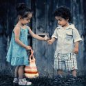 Two children holding a dandilion