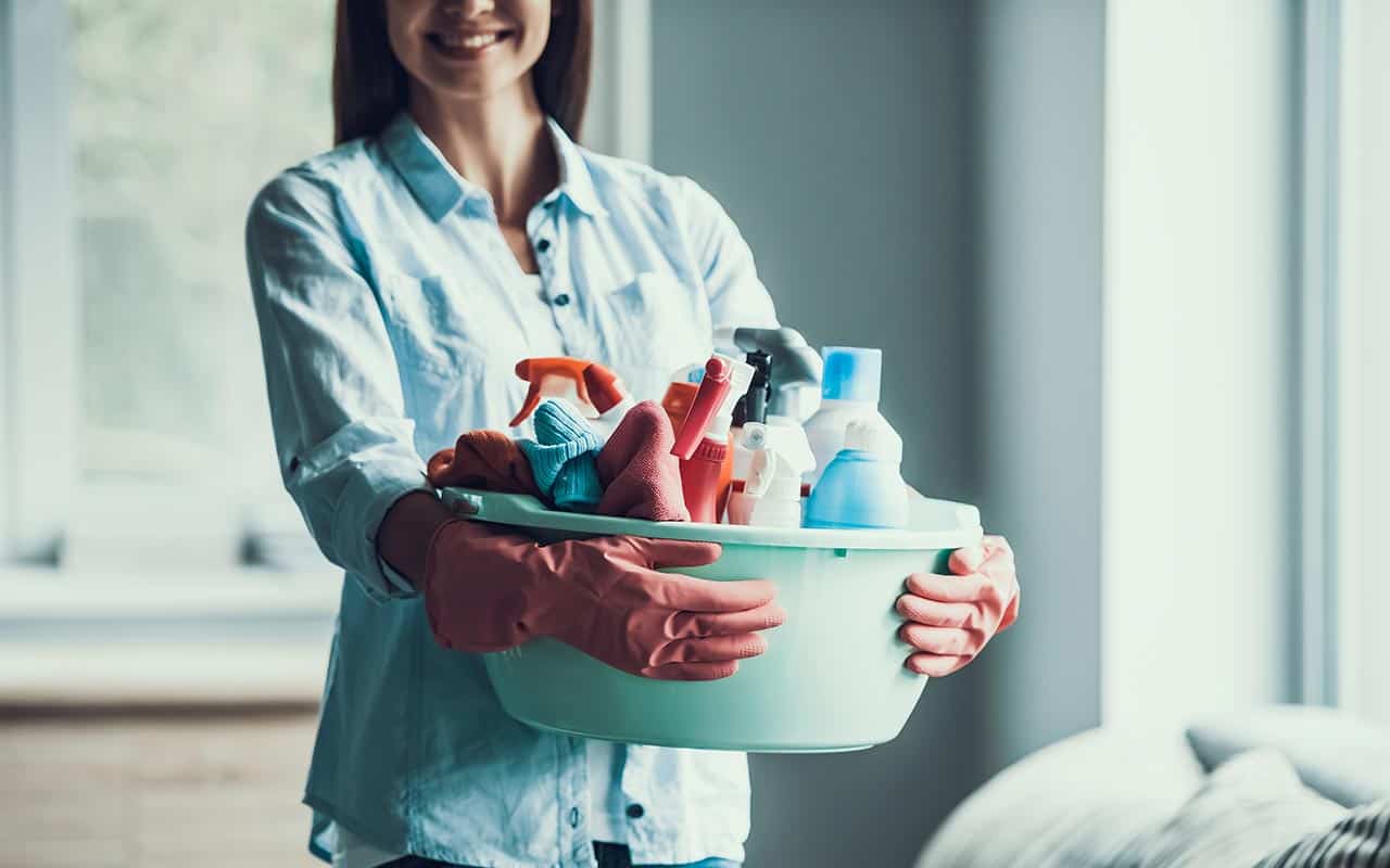 Housekeeper with cleaning supplies