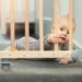 Baby holding crib rail