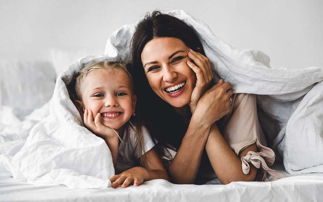 household staffing certfied nanny training A nanny and child play fort underneath blankets | Household Staffing