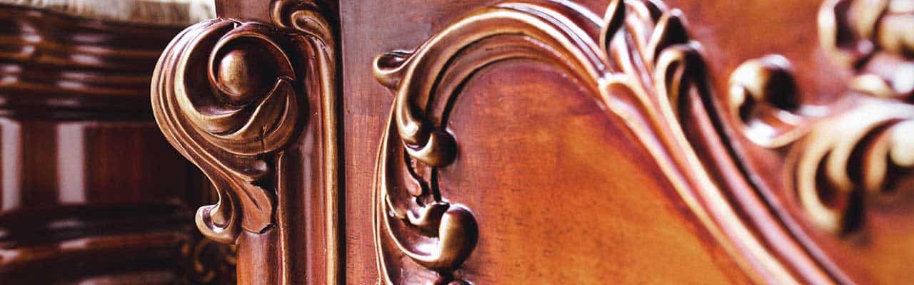 Closeup of an elegant carving on a fine hardwood dresser drawer