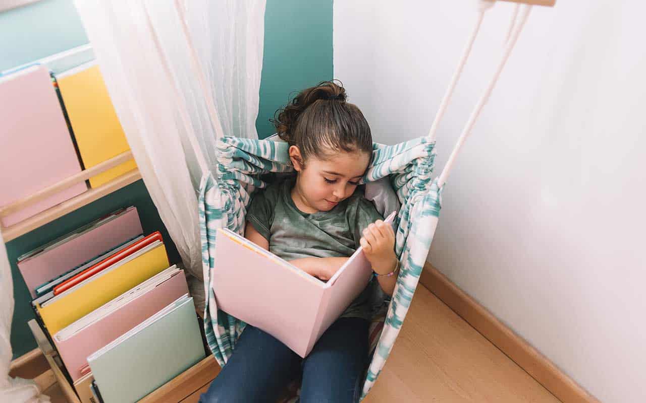 Waldorf inspired reading corner with wooden furniture and soft, natural fabrics | Household Staffing 